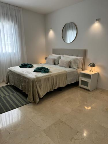 a bedroom with a large bed and a mirror at DREAM CALLAO in Santa Cruz de Tenerife