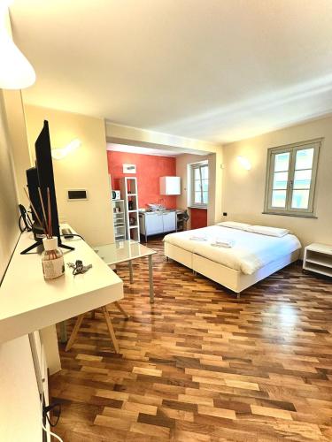 a bedroom with a bed and a desk with a computer at San Filippo Studio Biella Centro in Biella