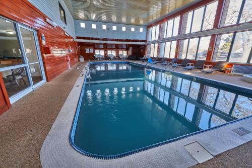 a large swimming pool in a building at The Mariner Resort Cape Cod by The Red Collection in West Yarmouth