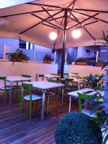 a restaurant with tables and chairs and an umbrella at MA Hotel in Santa Margherita Ligure