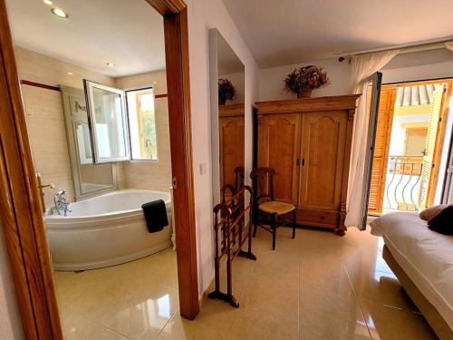a bathroom with a bath tub and a bed at Portmán Chillout in Portman