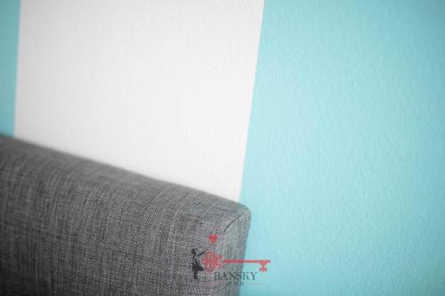 a close up of a couch against a blue wall at Tiffany's Studio - Lugano in Style -By EasyLife Swiss in Lugano
