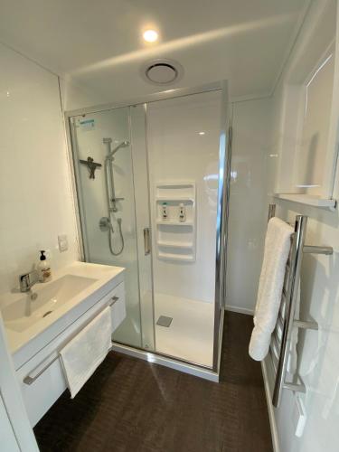 a bathroom with a shower and a sink at Birch Court - Tui in Whanganui