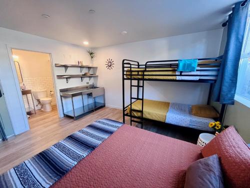 a room with two bunk beds and a couch at Monterey Hostel in Monterey