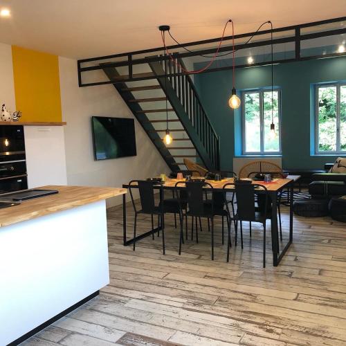 une cuisine et une salle à manger avec une table et des chaises dans l'établissement La Tranquilitude, à Ceyzérieu