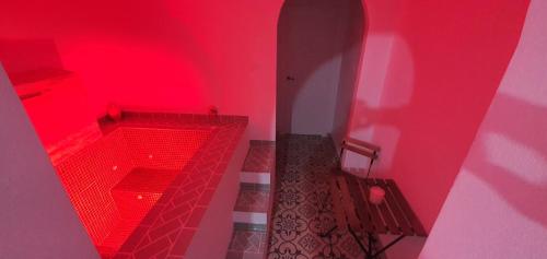 a red room with a bathroom with red walls at La Morería y su jacuzzi in La Puebla de los Infantes