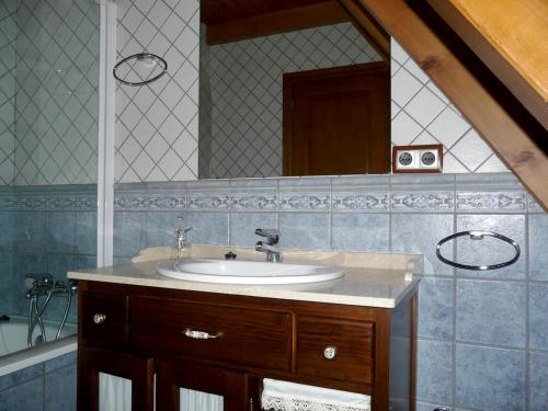 a bathroom with a sink and a mirror at 3 bedrooms chalet with city view furnished garden and wifi at Viella in Vielha