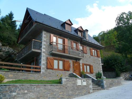 a large brick building with a black roof at Charming Chalet in Viella, Mountain View in Vielha