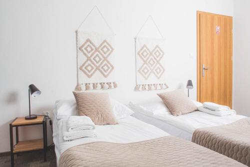 two beds sitting next to each other in a room at Beskidian in Węgierska Górka