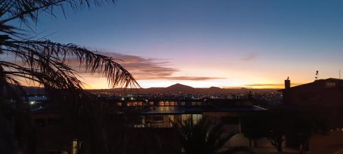 a view of a city at sunset at SapphireA@54 in Windhoek