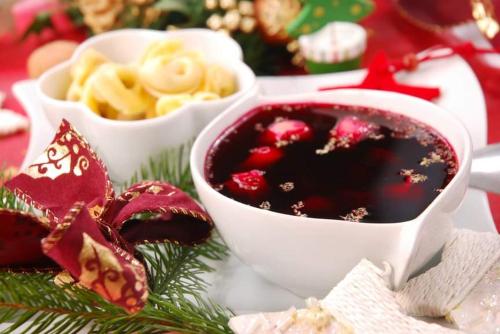a plate of food with a bowl of cranberry sauce at Hotel Graal Targowisko in Targowisko
