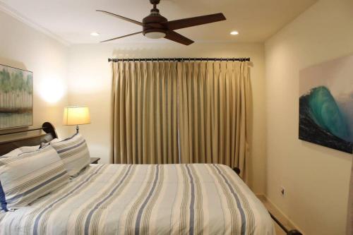 a bedroom with a bed and a ceiling fan at Best Ocean & Bay Views in SD Large Backyard Air Conditioning in San Diego