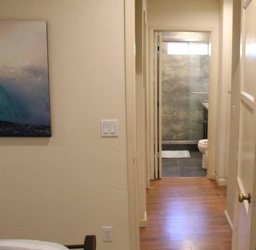 a hallway with a bathroom with a toilet and a sink at Best Ocean & Bay Views in SD Large Backyard Air Conditioning in San Diego