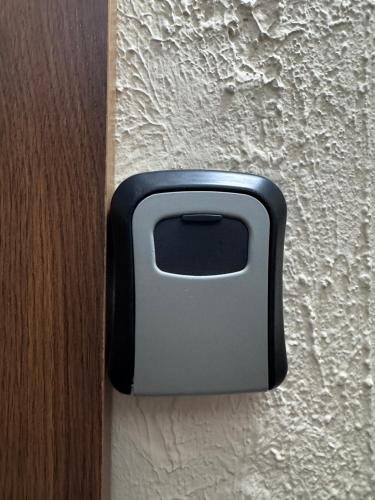 a black and gray object on a wall at Cozy Self Check-in CITY CENTRE apartment in Mažeikiai