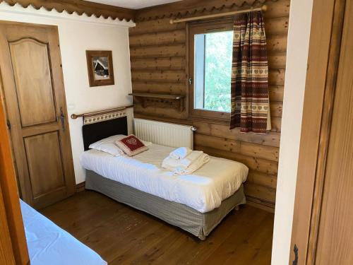 sypialnia z łóżkiem w pokoju z oknem w obiekcie Résidence La Ginabelle - maeva Home - Appartement 3 pièces 6 personnes - Sélection MAE-2964 w Chamonix-Mont-Blanc