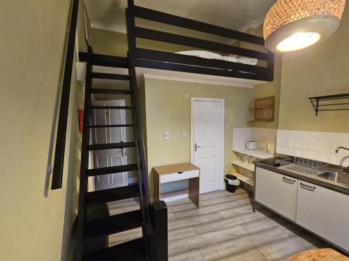 a kitchen with a spiral staircase in a room at Boutique Studio in King's Cross in London