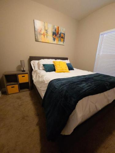 a bedroom with a bed with a yellow pillow on it at Small backyard getaway in Spring