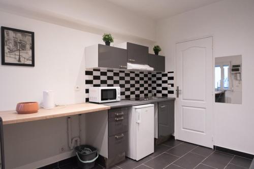 a kitchen with a counter top with a microwave at Lovely studio in Paris in Paris