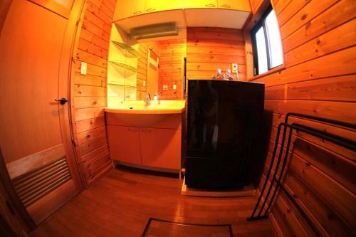 a bathroom with a sink and a mirror at WAKURABA- Chalet with the best views in Hakuba! in Hakuba