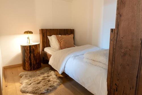 a bedroom with a bed and a table with a lamp at Guest Accommodation Butina in Kuterevo