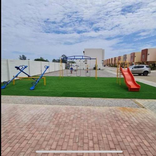 a playground with a slide and a swing set at Departamento Coral Vía a Data in Playas