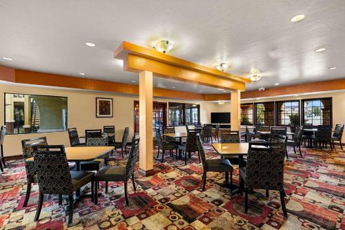a restaurant with tables and chairs in a room at Best Western Moreno Hotel & Suites in Moreno Valley