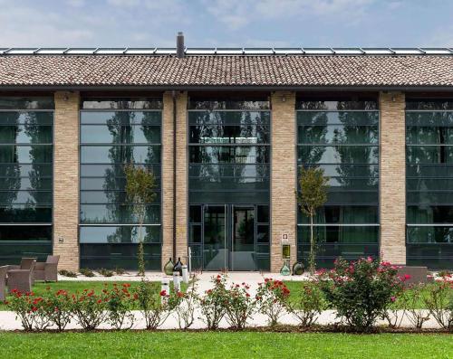 a large brick building with a lot of windows at Best Western Hotel Green City in Parma