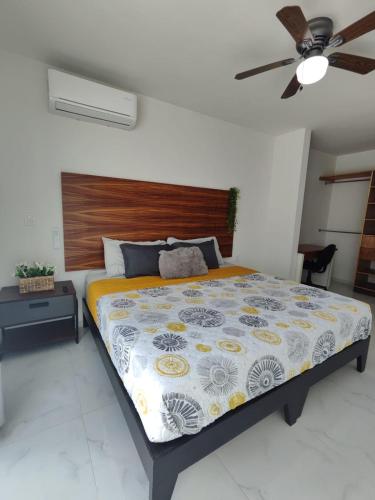 a bedroom with a bed and a ceiling fan at Pent-house a media cuadra del malecón, Hookipa Tower! in Mazatlán