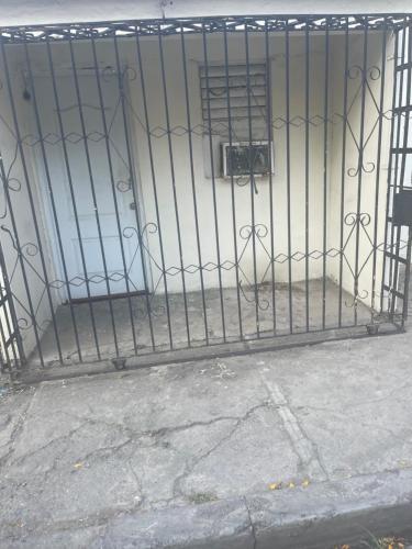 a gate of a building with a sign on it at Beckroom in Cotuí