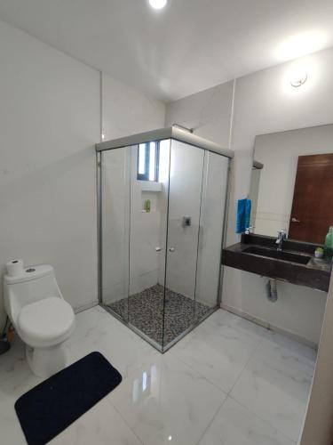 a bathroom with a shower and a toilet and a sink at Pent-house a media cuadra del malecón, Hookipa Tower! in Mazatlán