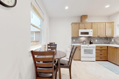 a kitchen with a table and chairs and a clock at Sol Retreat in Rockaway Beach