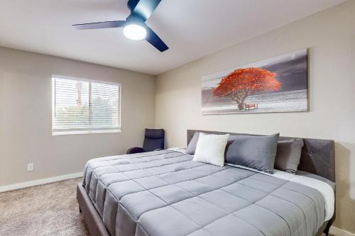 a bedroom with a bed and a ceiling fan at Chandler's Hidden Gem in Chandler