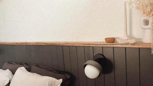 a shelf above a bed with a hat on it at Studio on Home in Albany
