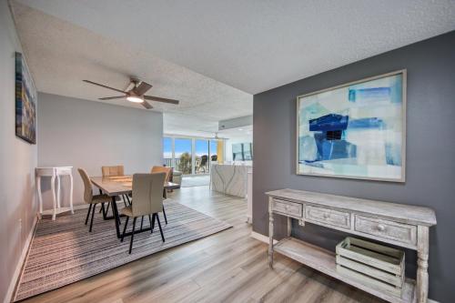 a living room with a table and a dining room at Huge Beachfront Condo on Maderia Beach in St. Pete Beach