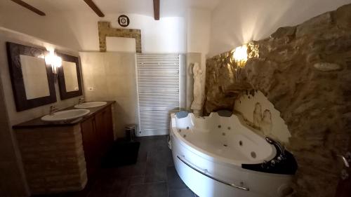 a bathroom with a large tub and a sink at Murisengo Country Houses in Murisengo