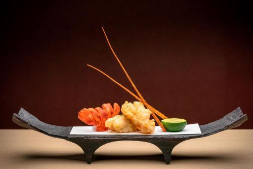 a plate of food with shrimp and a lime at Chalet Ivy Jozankei in Jozankei