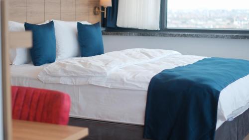 a bedroom with a bed with blue and white pillows at The Blue Suites in Istanbul