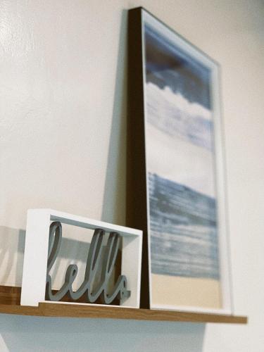 a shelf with a picture of the ocean on it at Gloria's Beach House in Oslob