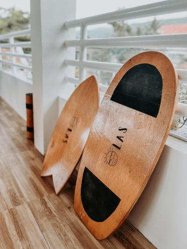 two wooden surfboards sitting on top of a floor at Gloria's Beach House in Oslob