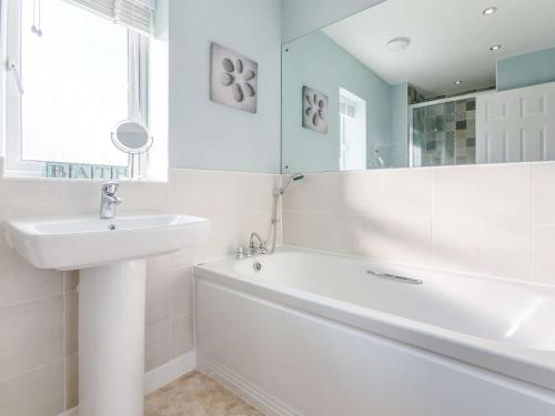 a white bathroom with a tub and a sink at 4 Bed in Westward Ho 85367 in Westward Ho