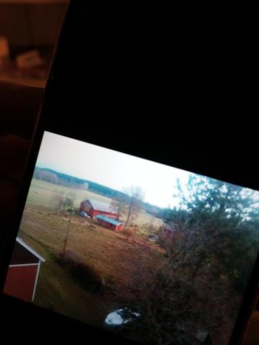 a view of a farm with a barn in a field at Espanja in Kotka