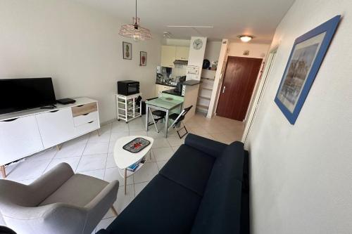 un salon avec un canapé et une table dans l'établissement Cosy love cocoon close to the sea, à La Baule