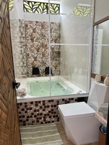 a bathroom with a green tub with a window at Finca Don Matías in Melgar