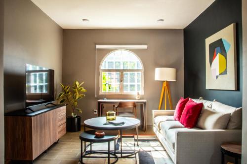 a living room with a couch and a tv at HUATUSCO By Mr W in Mexico City
