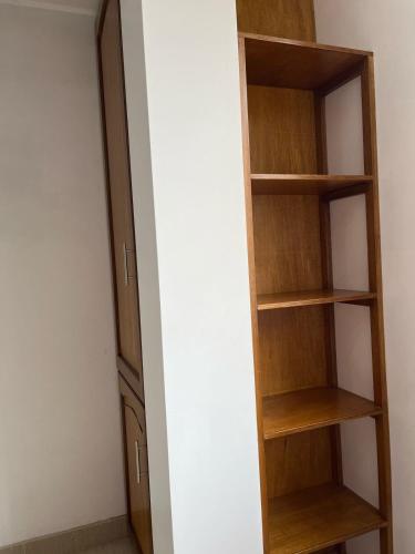 a closet with wooden shelves in a room at CASA FAMILIAR in Huaraz