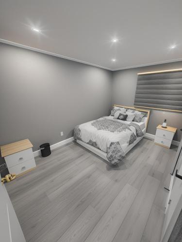 a bedroom with a large bed and wooden floors at Classic & Luxury Private Detached Entire Home with Free WI-FI & T.V in Brampton