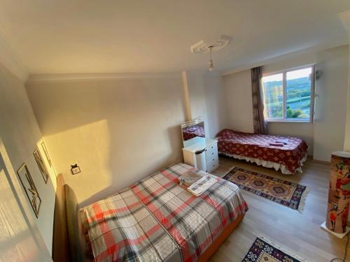 a small bedroom with a bed and a window at Stay in nature-5 mins to airport in Arnavutköy