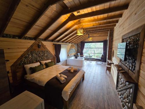a bedroom with a large bed in a cabin at Gülhan Butik Hotel & Bungalov in Rize