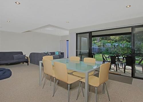 a dining room with a glass table and chairs at Sandy Place 75B Seaside Living in Long Beach