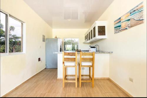 a kitchen with a counter and a refrigerator at apartamento EL CORAL in Río San Juan